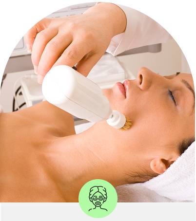 Woman at spa receiving device facial treatment