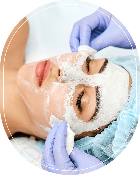 Woman receiving a facial mask treatment at a spa.