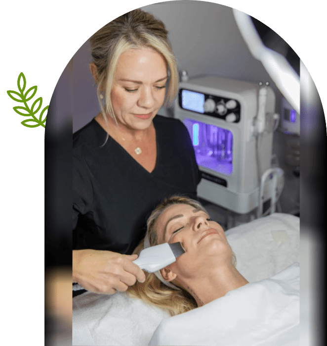 Aesthetician performing ultrasonic facial treatment