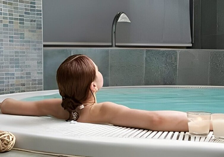 Woman relaxing in a spa jacuzzi bath.
